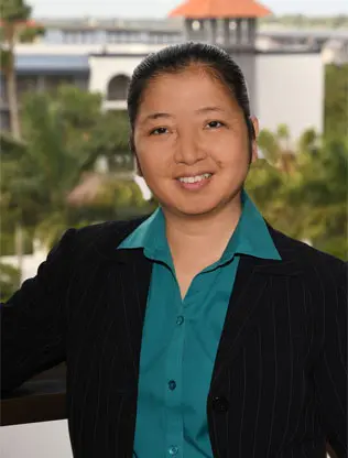 A woman in a black jacket and blue shirt